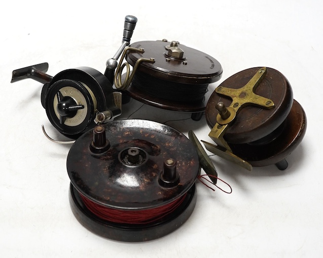 Four fishing reels, including a Bakelite Alcock Aerialite, an Elo, a Seprage C.A.P and a wooden reel, largest 10.5cm diameter. Condition - used, fair